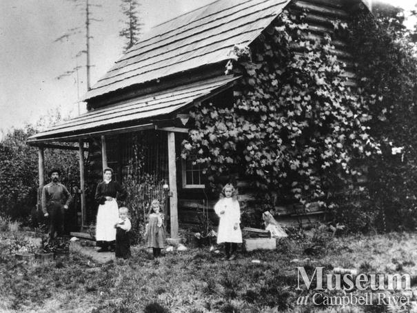 The Wilson family in front of their home on Quadra Island