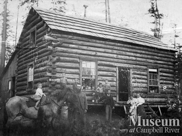 The Yeatmans in front of their log cabin at Sunnyside Farm, Quadra Island
