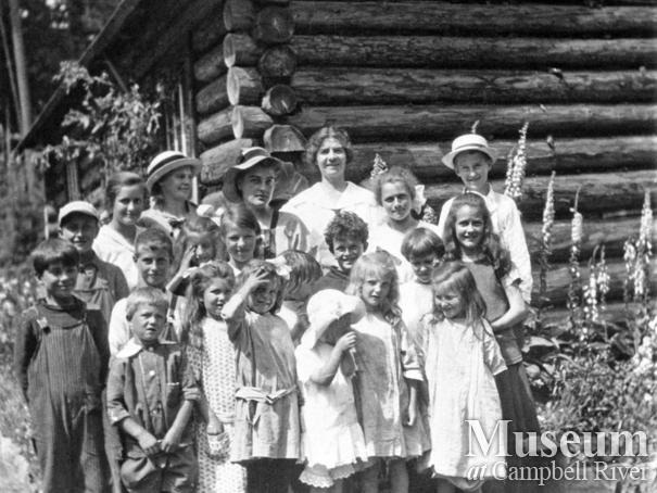 Group of students in front of their school at Mansons Landing, Cortes Island
