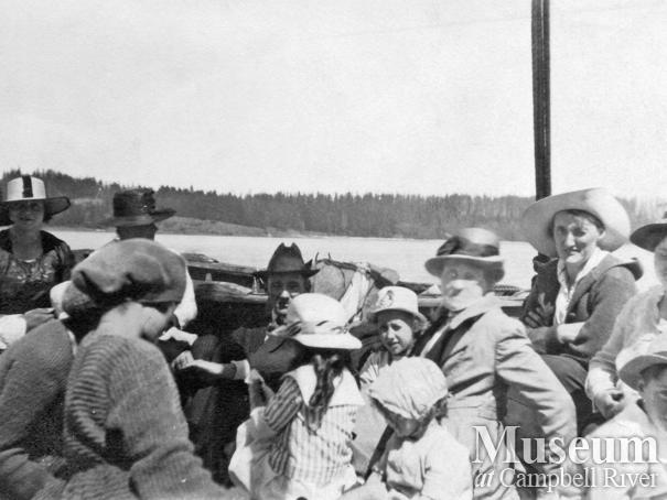 Group of early Quadra Island residents on board a boat in Quathiaski Cove	