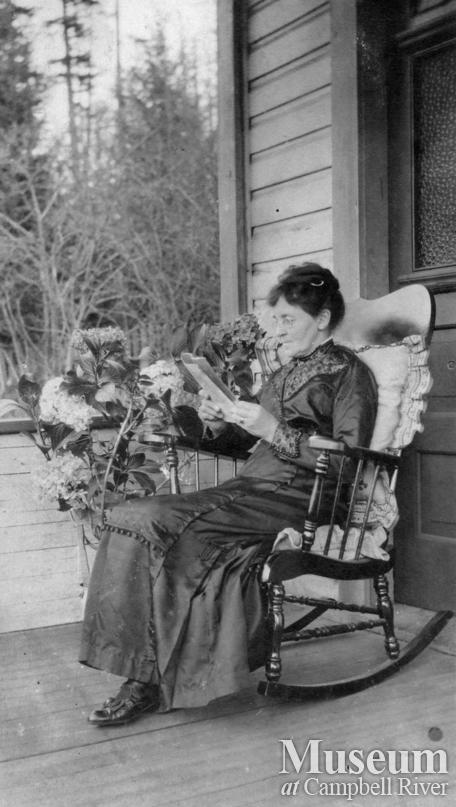 Emma Yeatman on front porch of her Quadra Island home	