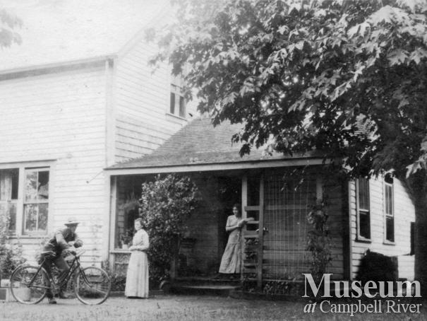 Members of the Yeatman family on the back porch of their home, Quadra Island