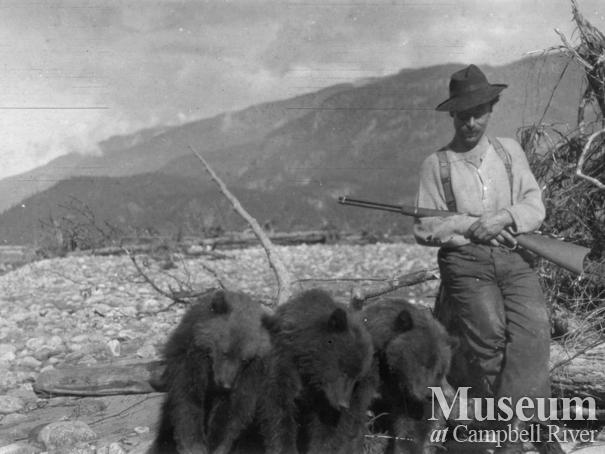 Ray Walker with Three Dead Grizzlies shot for bounty at Knight’s Inlet