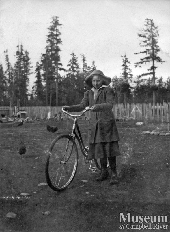 Possibly a member of the Joyce family with her bicycle, Quadra Island