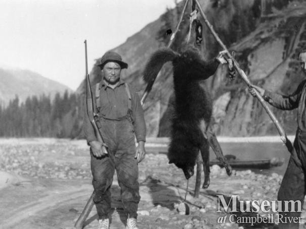 August Schnar and Ed Atkins with dead wolf