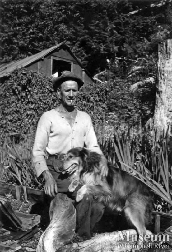 "Slim" and his dog at his homestead at Ramsey Arm