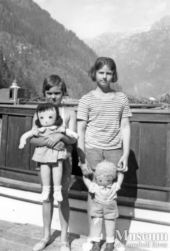 Two of the Eilel Family's children with their toy dolls