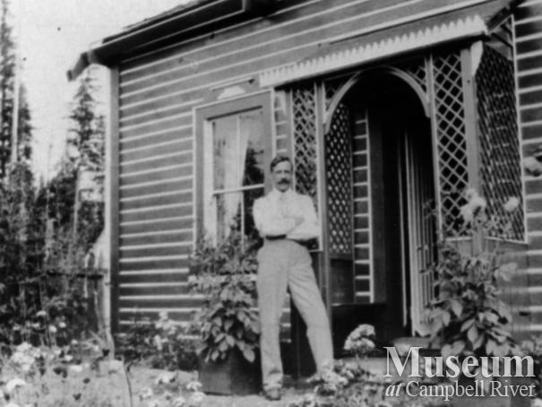 Gentleman in front garden of J. Hovell’s home, Quadra Island	