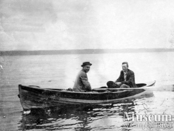 Paul and Roy Marlatt in a wooden rowboat