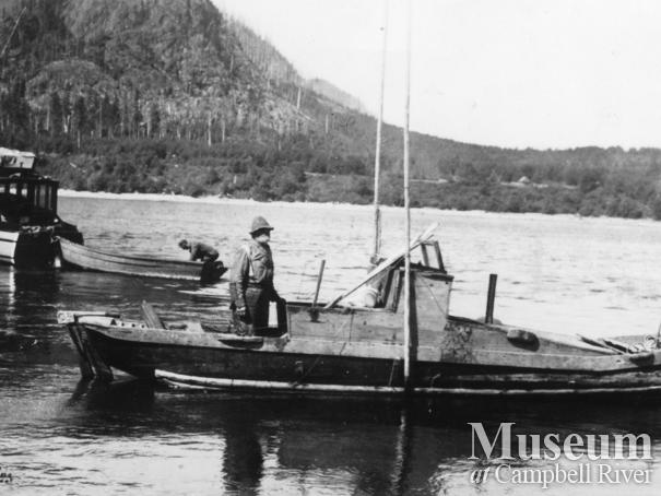 Alex Burchett on the boat he built and named the "Orphan Annie"