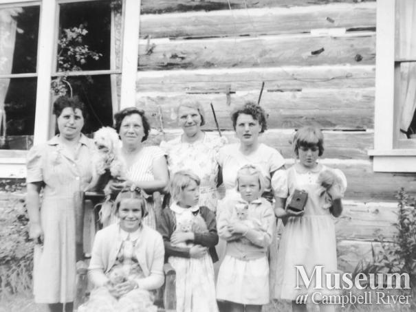 Members of the Hansen family in front of their home at Port Neville